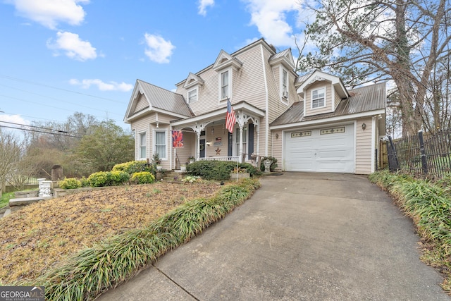 view of front property featuring covered porch and a garage