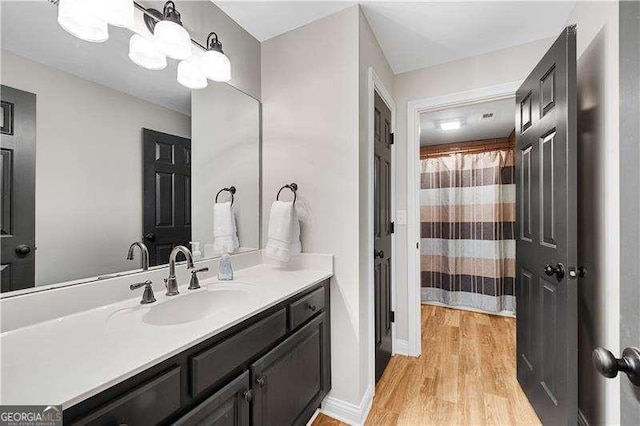 bathroom with hardwood / wood-style floors and vanity