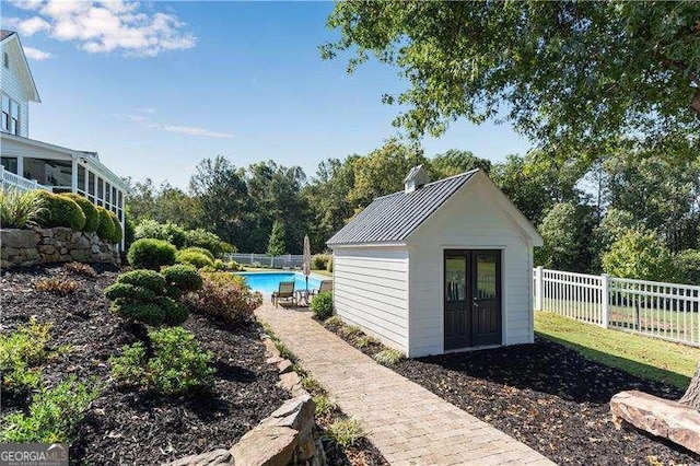 view of outdoor structure with a fenced in pool