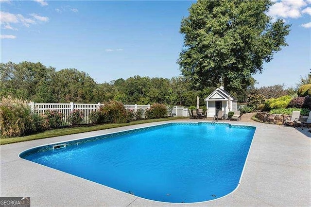 view of pool featuring an outbuilding and a patio