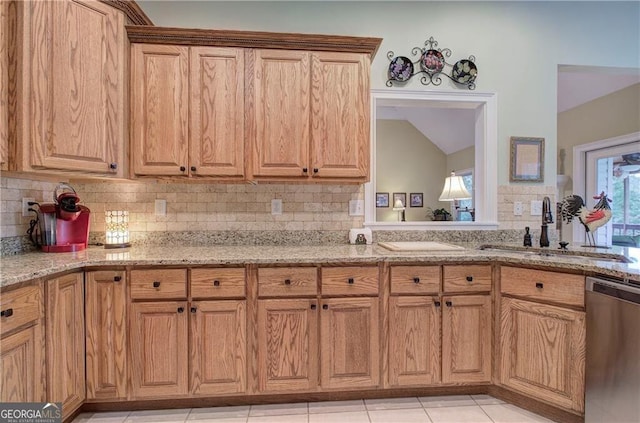 kitchen featuring sink, dishwasher, light stone counters, light tile patterned floors, and decorative backsplash