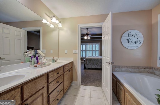 bathroom featuring ceiling fan, vanity, a bathtub, and tile patterned floors