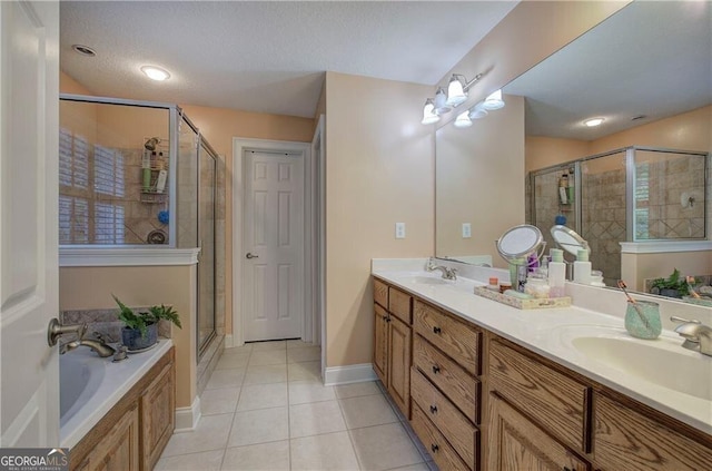 bathroom featuring a textured ceiling, separate shower and tub, vanity, and tile patterned flooring