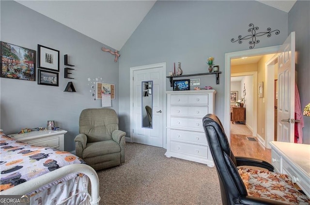 bedroom featuring high vaulted ceiling and carpet flooring