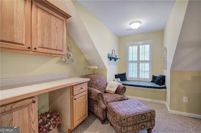 sitting room featuring light carpet, lofted ceiling, and a textured ceiling