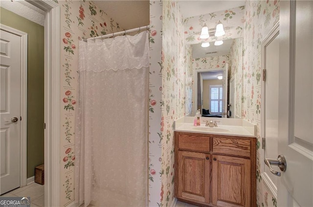 bathroom with tile patterned flooring, curtained shower, and vanity