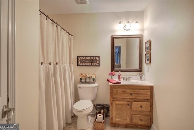 bathroom featuring toilet, tile patterned flooring, and vanity