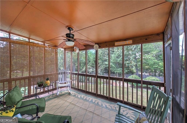 unfurnished sunroom featuring ceiling fan