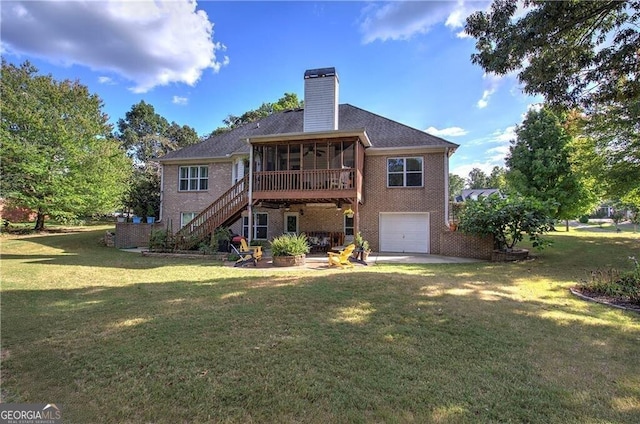 back of property with a garage, a patio, a lawn, and a sunroom