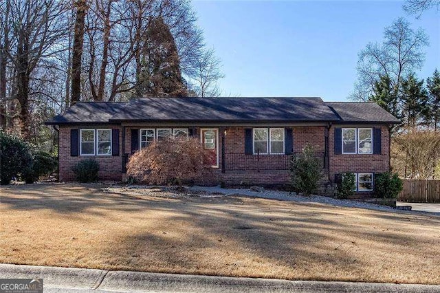 ranch-style home with a front lawn