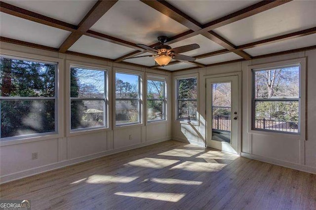 unfurnished sunroom featuring coffered ceiling, ceiling fan, and beam ceiling