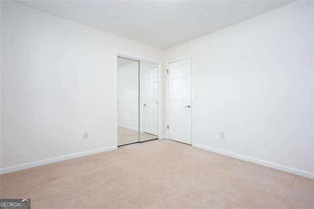 unfurnished bedroom featuring light carpet