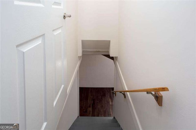 staircase with hardwood / wood-style floors