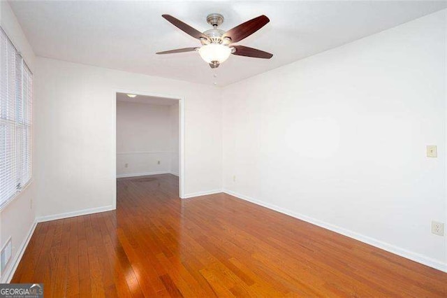 spare room featuring hardwood / wood-style flooring and ceiling fan