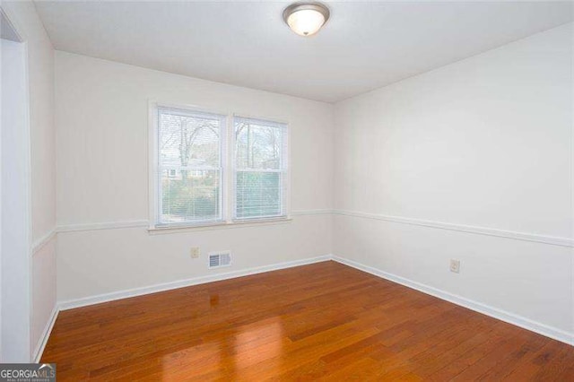 spare room featuring hardwood / wood-style flooring