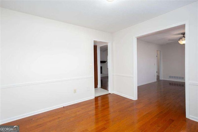 unfurnished room with hardwood / wood-style flooring and ceiling fan