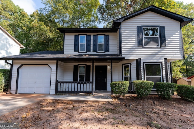 view of front property with a porch and a garage