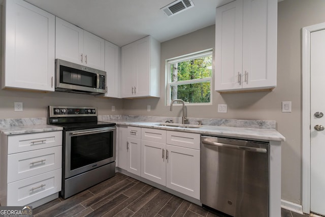 kitchen featuring white cabinetry, sink, and stainless steel appliances