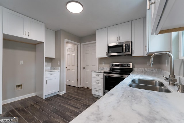 kitchen with sink, stainless steel appliances, and white cabinets