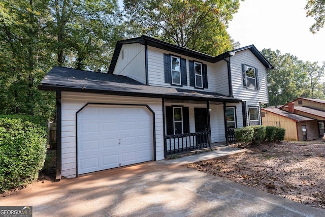 front facade with covered porch and a garage