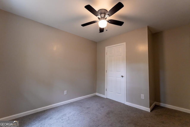 unfurnished bedroom featuring dark colored carpet and ceiling fan