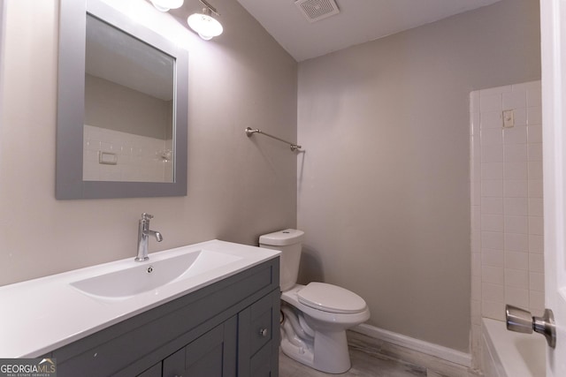 full bathroom featuring toilet, vanity, hardwood / wood-style floors, and shower / bathing tub combination