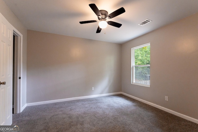 spare room featuring ceiling fan and carpet