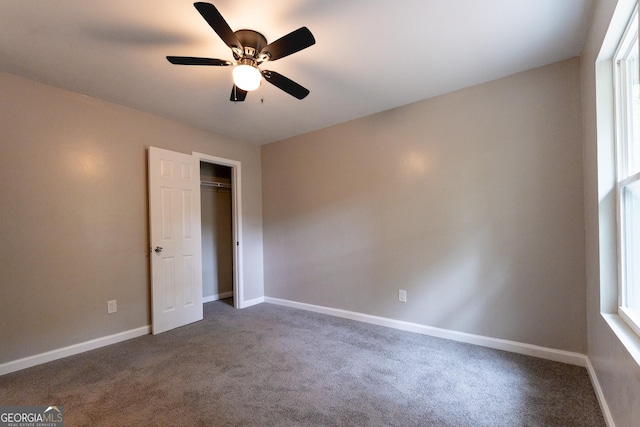 unfurnished bedroom featuring carpet, a closet, and ceiling fan