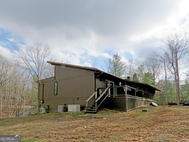 view of side of home with stairs