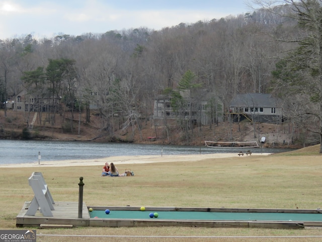 view of property's community featuring a water view and a lawn