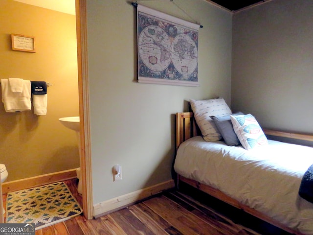 bedroom featuring baseboards and wood finished floors