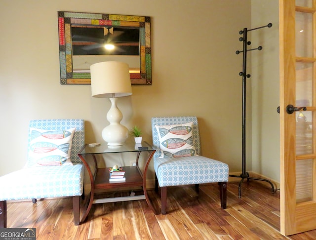 sitting room with wood finished floors and baseboards