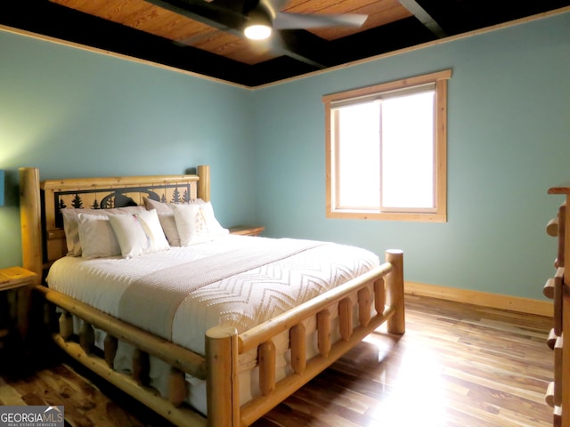 bedroom with baseboards, wooden ceiling, ceiling fan, light wood-style floors, and beam ceiling