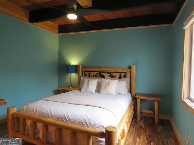 bedroom featuring wooden ceiling, baseboards, wood finished floors, and beamed ceiling