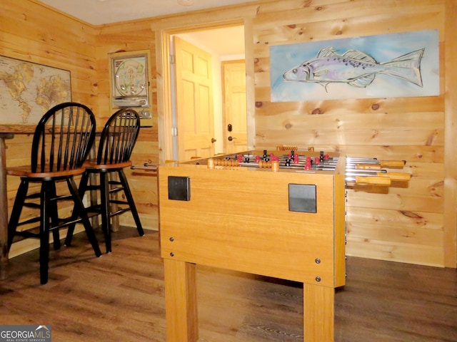 interior space with dark wood-type flooring and wood walls