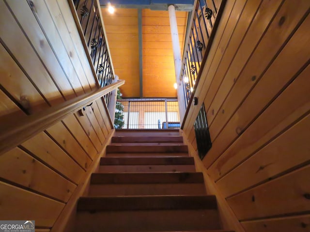 stairs with wood walls