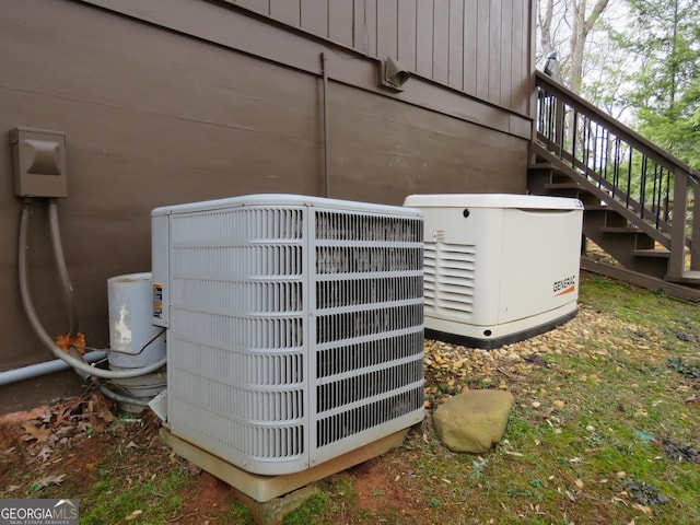 exterior details with stairs, a power unit, and central AC unit