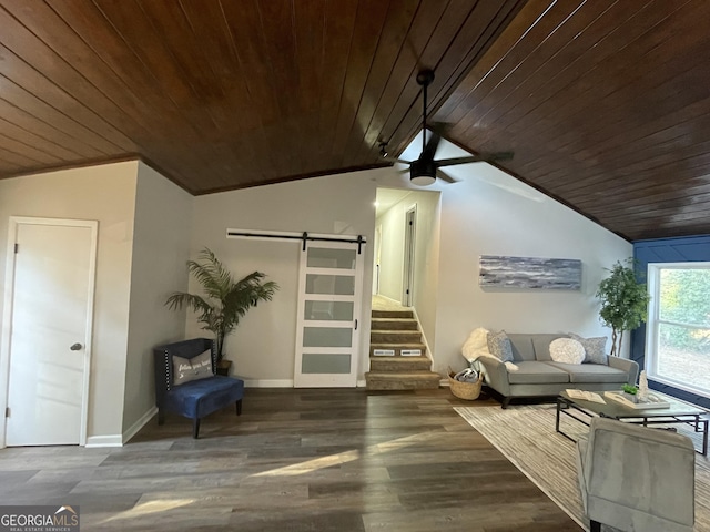 sitting room with stairway, a barn door, wood ceiling, vaulted ceiling, and wood finished floors