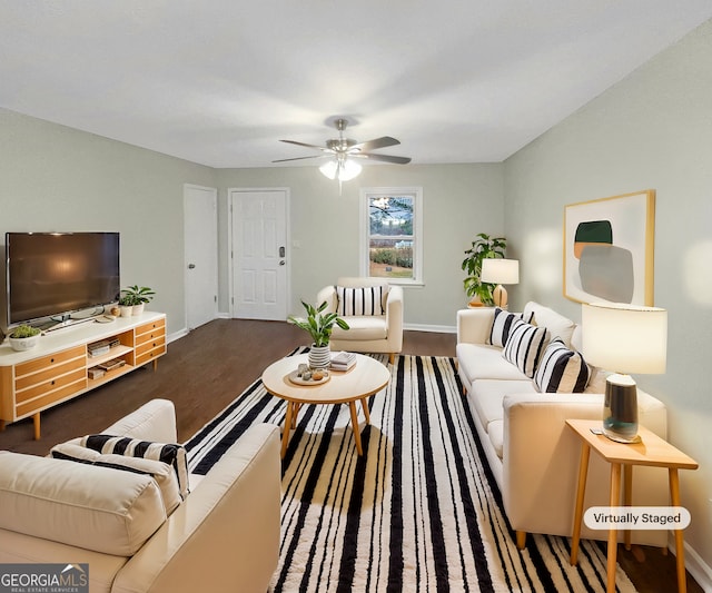 living area featuring dark wood-type flooring, a ceiling fan, and baseboards