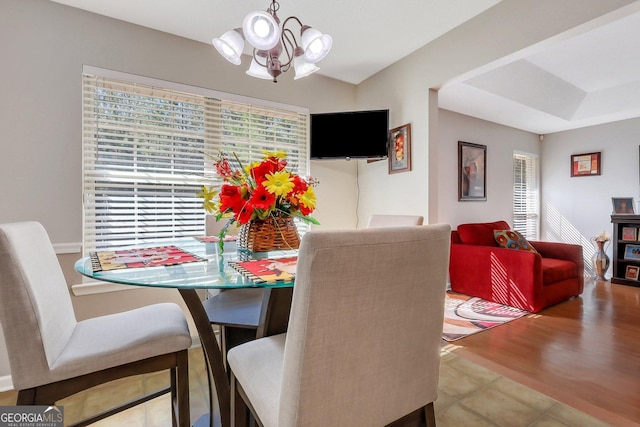 dining space with a chandelier and wood-type flooring