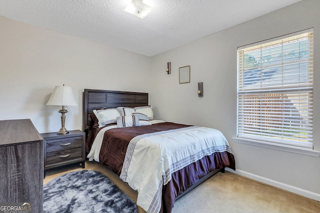 carpeted bedroom featuring a textured ceiling