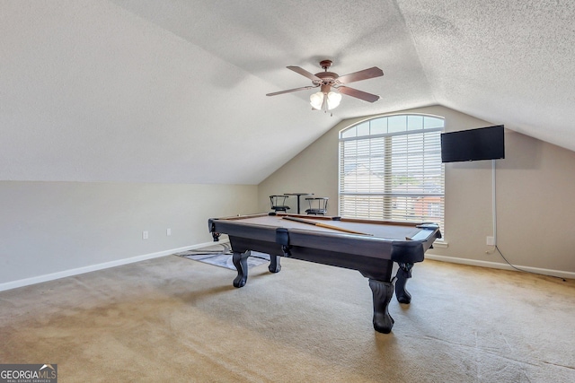 game room featuring a textured ceiling, vaulted ceiling, light colored carpet, and ceiling fan