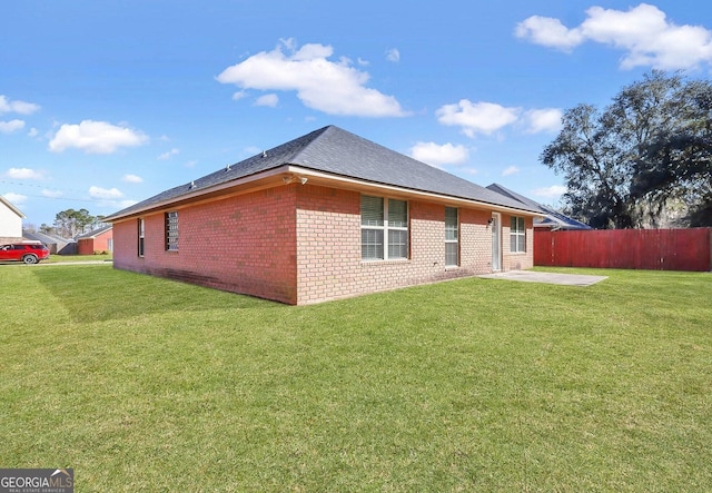 rear view of property with a patio area and a lawn