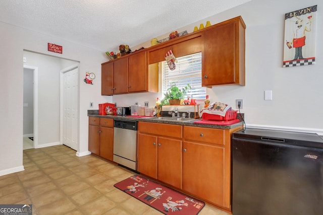 kitchen featuring refrigerator, dishwasher, a textured ceiling, and sink