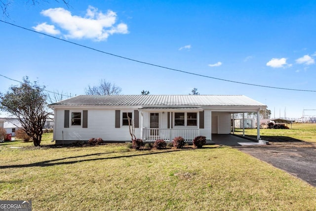 ranch-style house with a carport and a front lawn