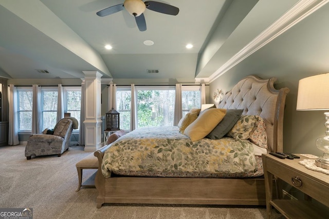 bedroom featuring multiple windows, lofted ceiling, ornate columns, and carpet floors