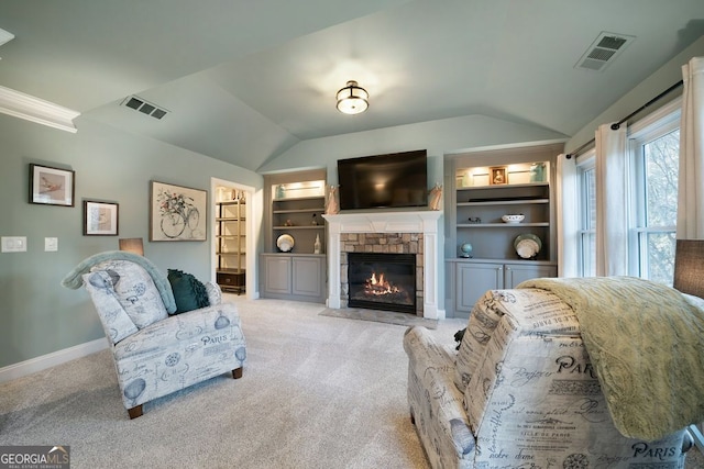 living room featuring light carpet, lofted ceiling, and a stone fireplace