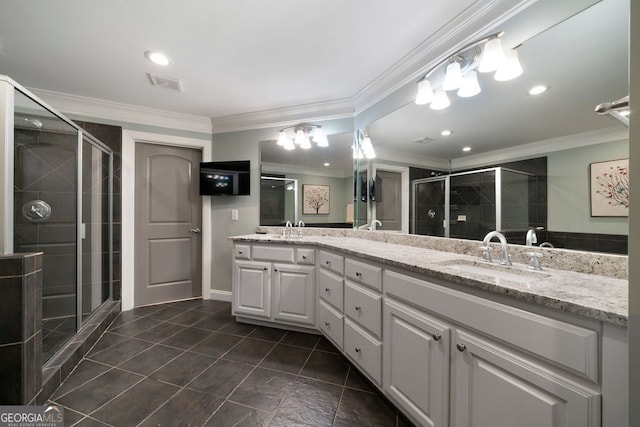 bathroom featuring tile patterned floors, a shower with shower door, vanity, and crown molding