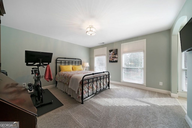 bedroom featuring light carpet