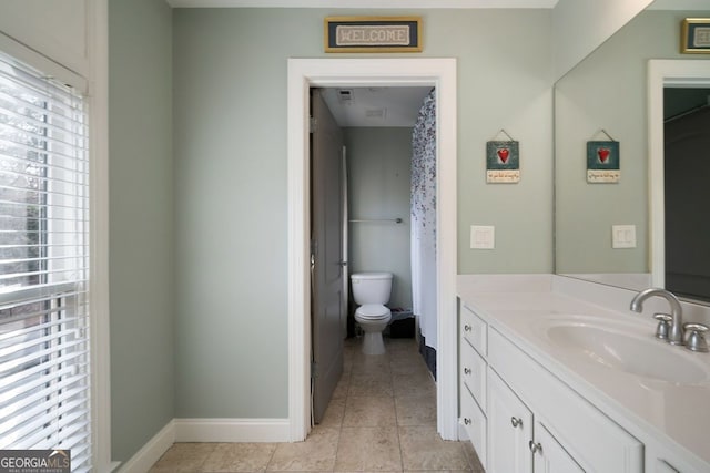 bathroom with vanity, toilet, and tile patterned floors